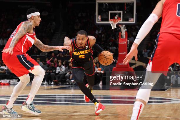 Dejounte Murray of the Atlanta Hawks drives to the basket during the game against the Washington Wizards on December 31, 2023 at Capital One Arena in...