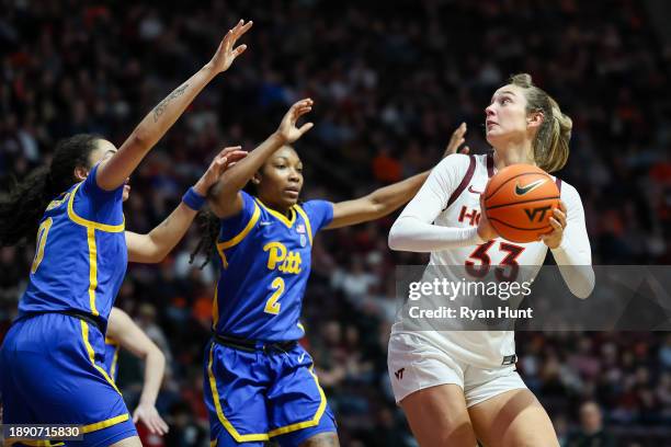 Elizabeth Kitley of the Virginia Tech Hokies shoots over Gabby Hutcherson and Liatu King of the Pittsburgh Panthers in the second half during a game...