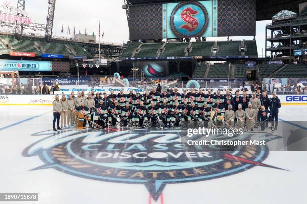 The Seattle Kraken pose for a team photo at center ice before the 2024 Discover NHL Winter Classic practice at T-Mobile Park on December 31, 2023 in...