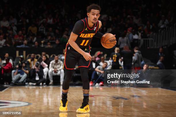 Trae Young of the Atlanta Hawks dribbles the ball during the game against the Washington Wizards on December 31, 2023 at Capital One Arena in...
