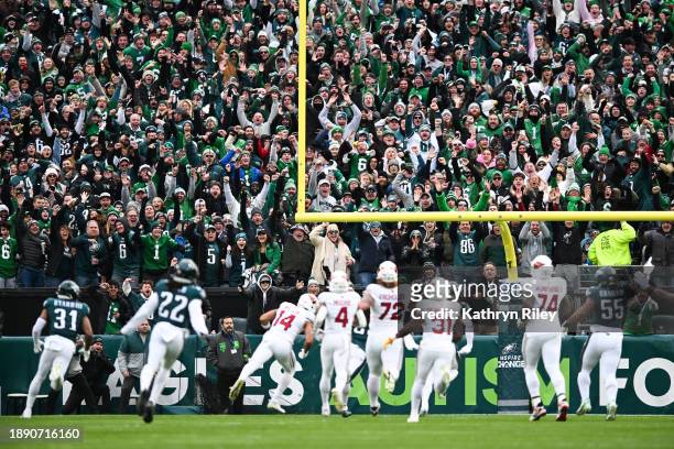 Fans react as Sydney Brown of the Philadelphia Eagles returns an interception for a touchdown during the first half against the Arizona Cardinals at...