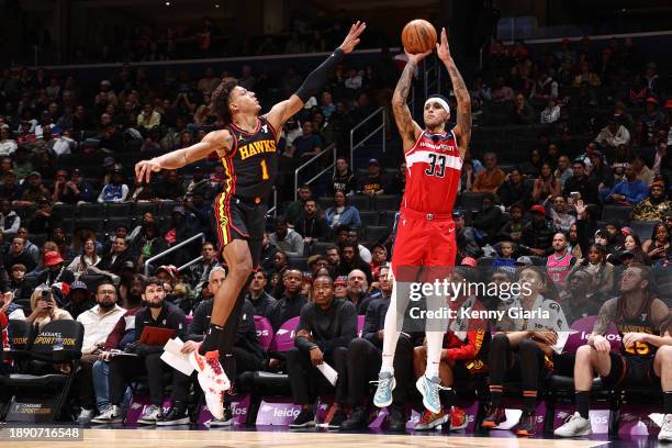 Kyle Kuzma of the Washington Wizards shoots a three point basket during the game against the Atlanta Hawks on December 31, 2023 at Capital One Arena...