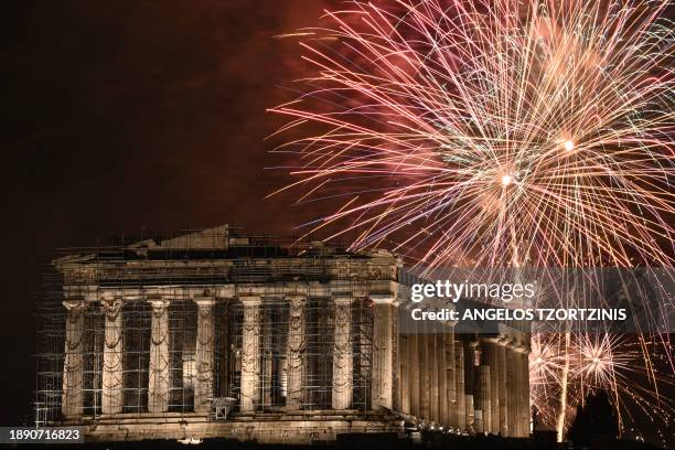 Fireworks explode over the Acropolis during New Year celebrations in Athens, early on January 1, 2024.