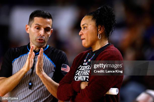 Official John Capolino explains a call to head coach Dawn Staley of the South Carolina Gamecocks during the game against the East Carolina Lady...