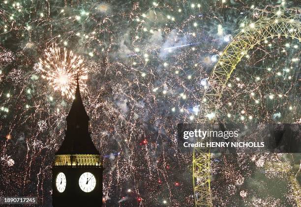 Fireworks explode around the London Eye and The Elizabeth Tower, commonly known by the name of the clock's bell, "Big Ben", at the Palace of...