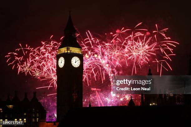 Fireworks light up the London skyline over Big Ben and the London Eye on January 1, 2024 in London, England. Each year thousands of people flock to...