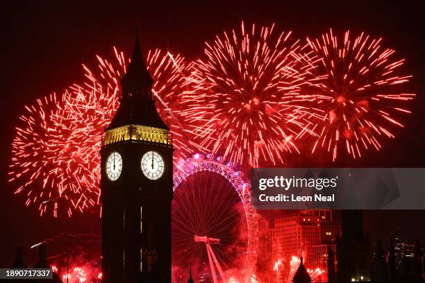 Fireworks light up the London skyline over Big Ben and the London Eye just after midnight on January 1, 2024 in London, England. Each year thousands...