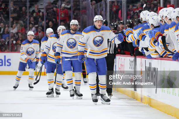 Tage Thompson of the Buffalo Sabres celebrates his first period goal against the Ottawa Senators with teammates at the players' bench at Canadian...