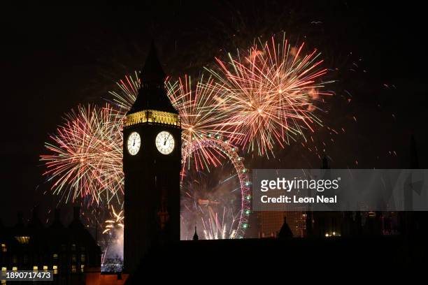 Fireworks light up the London skyline over Big Ben and the London Eye just after midnight on January 1, 2024 in London, England. Each year thousands...