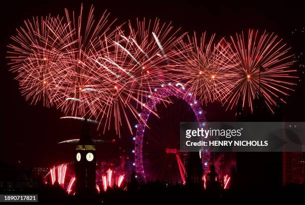 Fireworks explode around the London Eye and The Elizabeth Tower, commonly known by the name of the clock's bell, "Big Ben", at the Palace of...