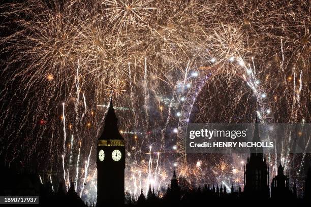 Fireworks explode around the London Eye and The Elizabeth Tower, commonly known by the name of the clock's bell, "Big Ben", at the Palace of...