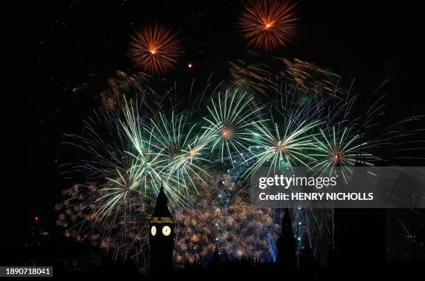 Fireworks explode around the London Eye and The Elizabeth Tower, commonly known by the name of the clock's bell, "Big Ben", at the Palace of...