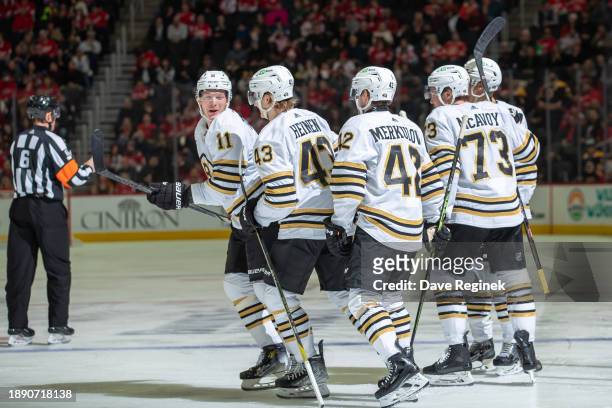 Trent Frederic of the Boston Bruins celebrates his goal with teammates against the Detroit Red Wings in the second period during the New Year's Eve...