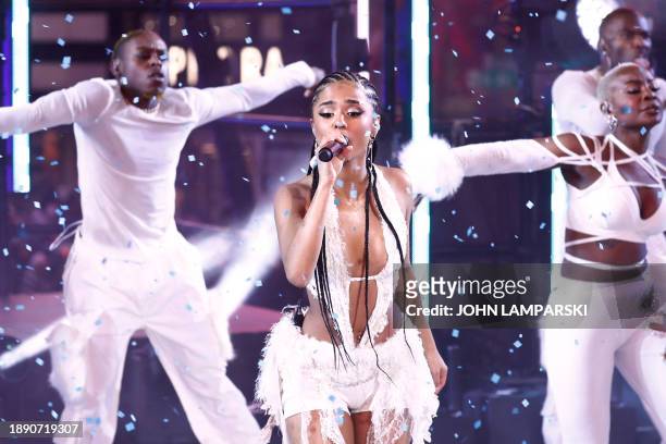 South African singer Tyla performs as revelers celebrate New Year's Eve in Times Square on December 31 in New York City.