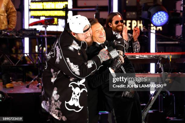 Rapper Jelly Roll hugs media personality and game show host, Ryan Seacrest, during the New Year's Eve celebration in Times Square on January 1 in New...