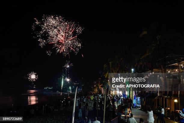 People enjoy fireworks during the New Year's Eve celebration in El Tunco beach on January 01, 2024 in La Libertad, El Salvador.