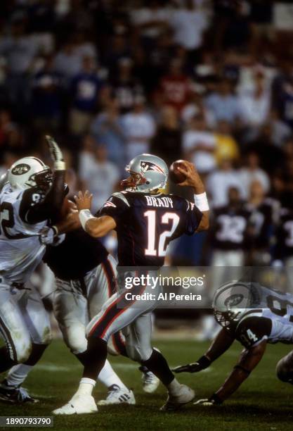 Quarterback Tom Brady of the New England Patriots passes the ball in the first game following the September 11 Attacks in the game between the New...