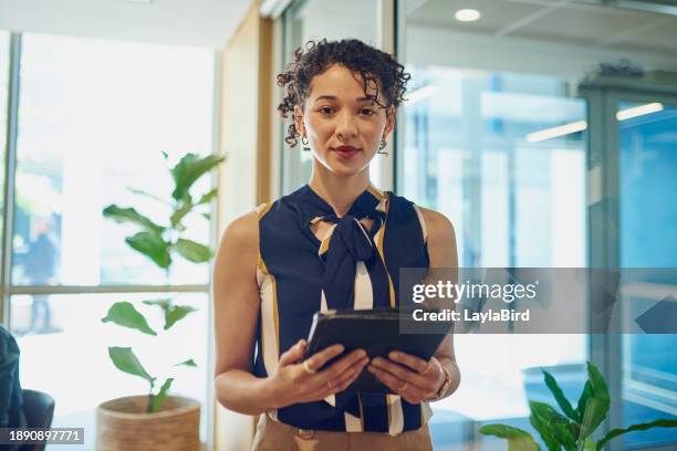 confident businesswoman standing in modern office holding tablet - best execution stock pictures, royalty-free photos & images