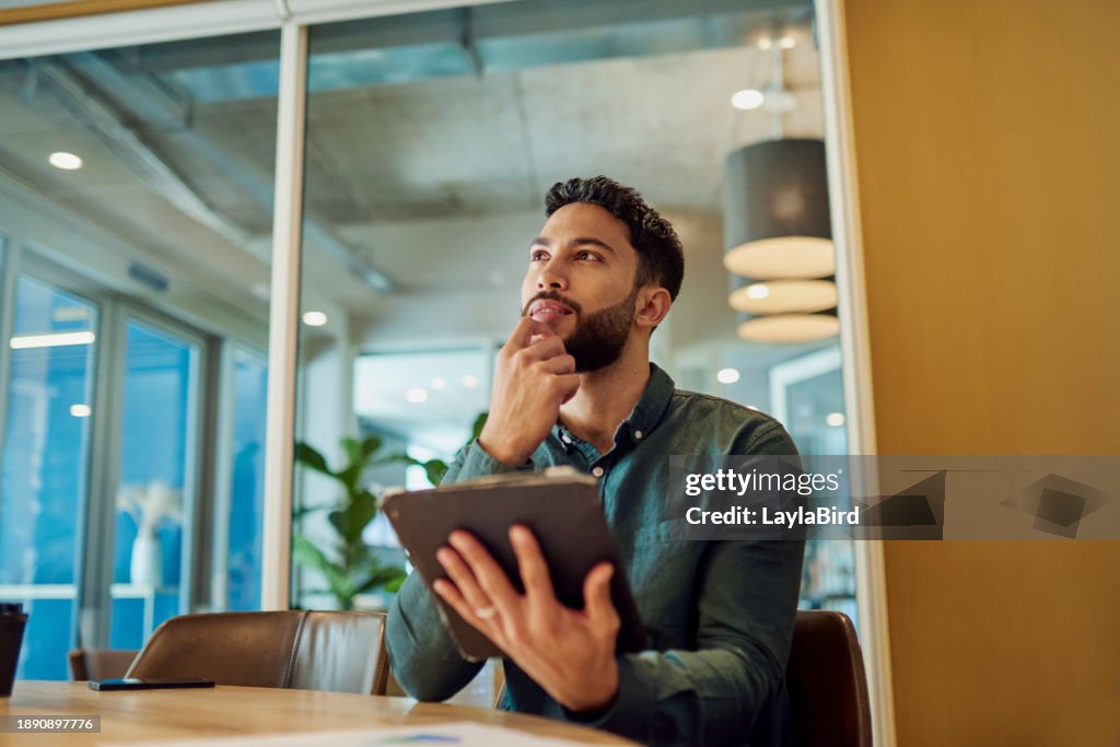 Thoughtful Businessman Contemplates Next Move While Analyzing Data on Tablet