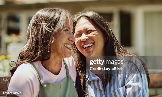 Two women laughing together outside