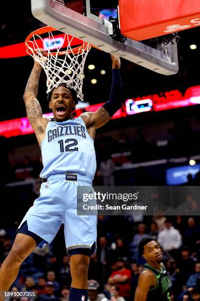 Ja Morant of the Memphis Grizzlies dunks the gall during overtime of an NBA game against the New Orleans Pelicans at Smoothie King Center on December...