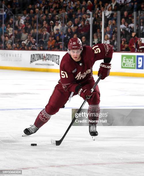 Troy Stecher of the Arizona Coyotes skates with the puck against the Colorado Avalanche at Mullett Arena on December 27, 2023 in Tempe, Arizona.