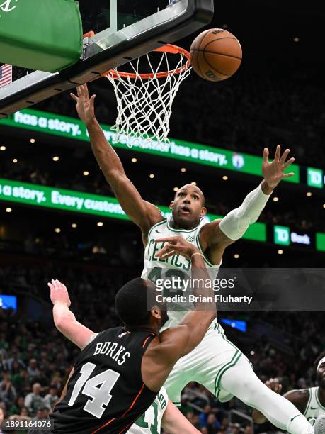 Alec Burks of the Detroit Pistons attempts a basket against Al Horford of the Boston Celtics during the fourth quarter at TD Garden on December 28,...