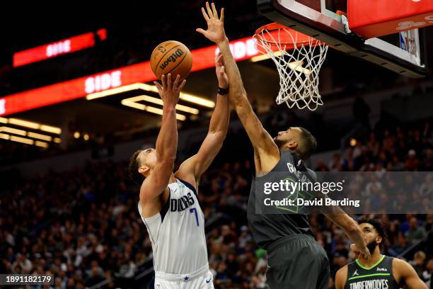 Dwight Powell of the Dallas Mavericks goes up for a shot while Rudy Gobert of the Minnesota Timberwolves defends in the third quarter at Target...