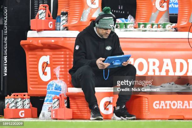 Aaron Rodgers of the New York Jets is seen on the bench against the Cleveland Browns at Cleveland Browns Stadium on December 28, 2023 in Cleveland,...
