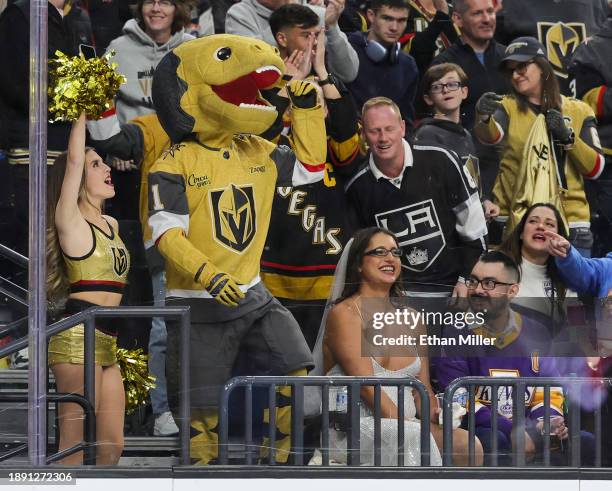 Member of the Vegas Golden Knights Vegas Vivas cheerleaders and mascot Chance the Golden Gila Monster celebrate a second-period goal goal by Michael...