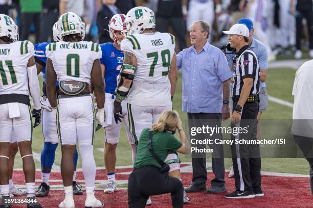 President George W. Bush tosses the coin during a game between Charlotte and Southern Methodist University at Gerald J Ford Stadium on September 30,...