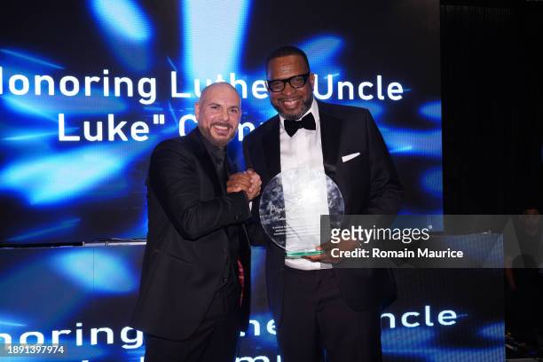 Pitbull and Uncle Luke attend Uncle Luke's birthday celebration at Level Three Miami on December 28, 2023 in Miami, Florida.