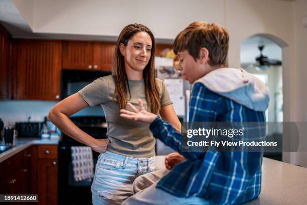 mother and son cheerfully talking at home - pre adolescent child stock pictures, royalty-free photos & images