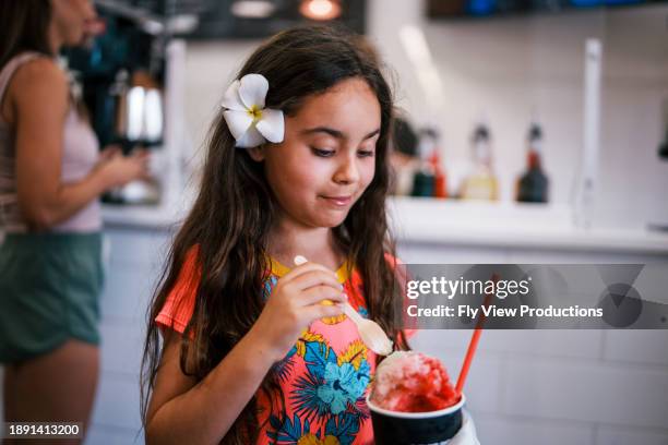 happy girl on vacation enjoying hawaiian shave ice - swimwear store stock pictures, royalty-free photos & images