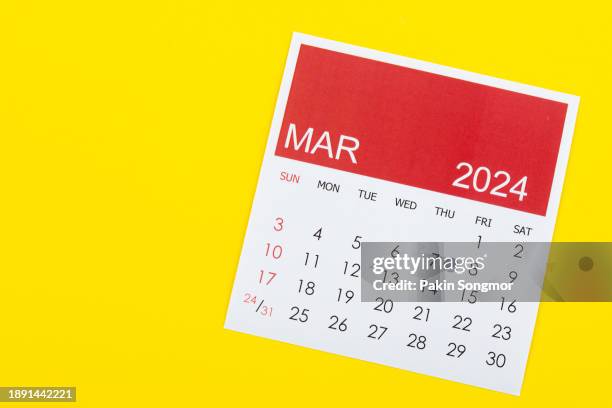 desk calendar 2024: march calendar is used to plan daily work and life on a yellow background. - march month stock pictures, royalty-free photos & images