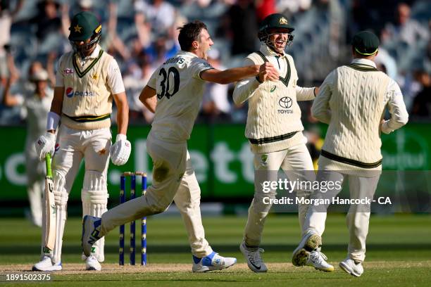 David Warner, Marnus Labuschagne and Pat Cummins of Australia celebrate the wicket of Shaheen Afridi of Pakistan during day four of the Second Test...