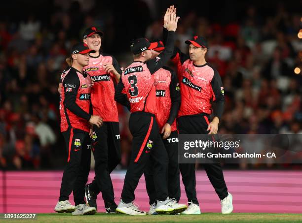 Mackenzie Harvey of the Renegades celebrates with his teammates after catching out Matt Short of the Strikers during the BBL match between Melbourne...