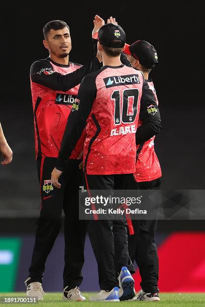 Mujeeb Ur Rahman of the Renegades and team mates celebrate the dismissal of Chris Lynn of the Sixers during the BBL match between Melbourne Renegades...