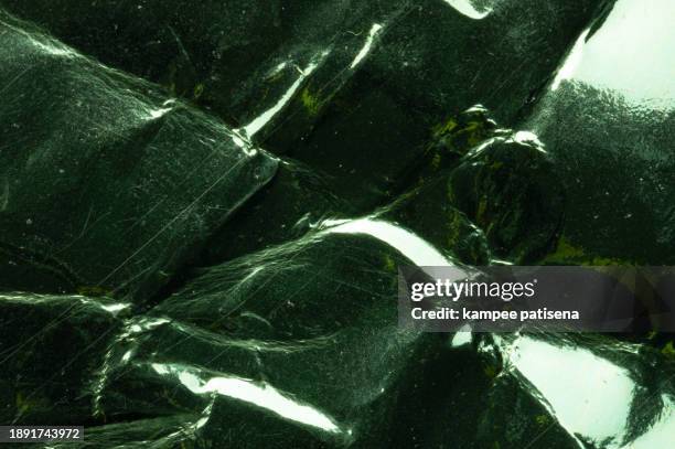 close up shiny crumpled green paper texture background. - tiered stock pictures, royalty-free photos & images
