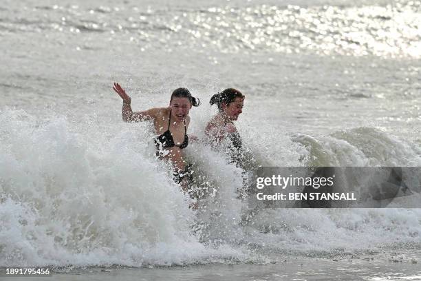 People take part in the annual New Year's Day Dip, on the beach in Ramsgate, south east England on January 1, 2024.
