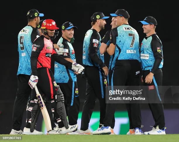Sixers celebrate with Harry Nielsen of the Sixers catching Quinton de Kock of the Renegades for a duck during the BBL match between Melbourne...