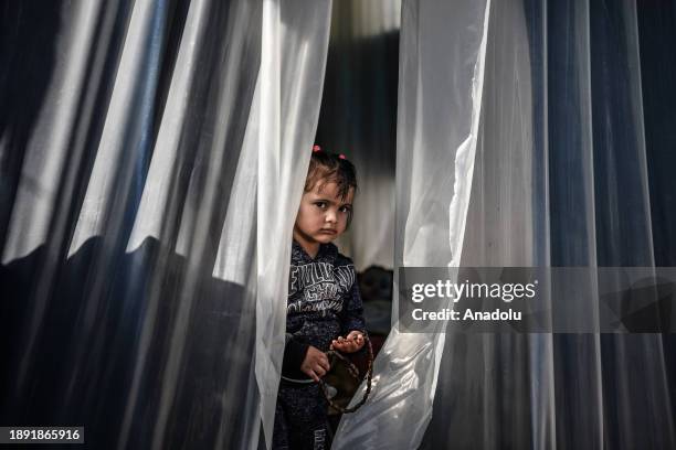 Palestinian families try to survive under harsh conditions in makeshift tents set up on empty fields after being forced to leave their homes due to...