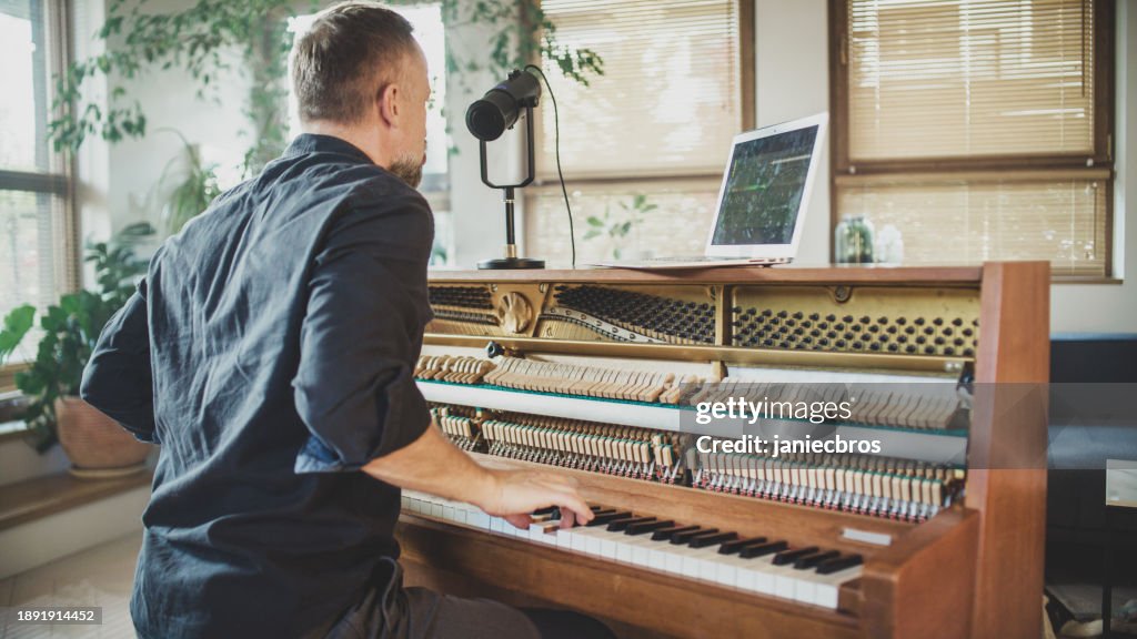 Male pianist playing classical music on an old piano and singing