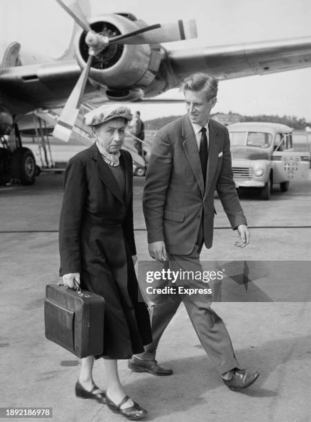 Evelyn Bassett, mother of British spy Guy Burgess, arriving at London Airport after visiting her son in Russia, August 7th 1956. 'He is very happy...