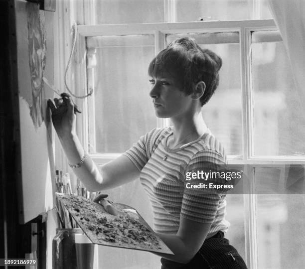 British artist Carlotta Barrow working on a painting at her studio in Bloomsbury, London, May 4th 1967.