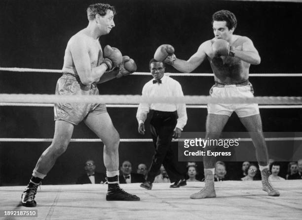 British singer and actor Frankie Vaughan filming a boxing scene from 'The Heart of a Man' with co-star Rupert Evans at Pinewood Studios, February...