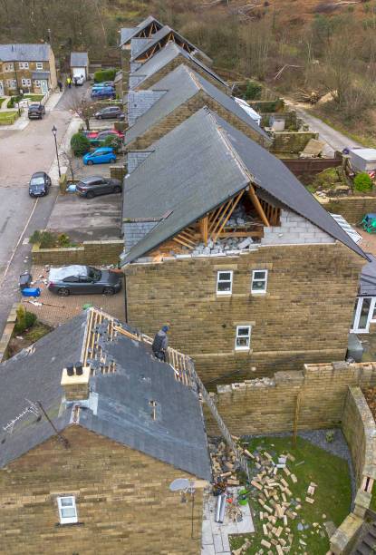 stalybridge-england-an-aerial-view-shows-a-workman-repairing-a-damaged-roof-on-calico.jpg