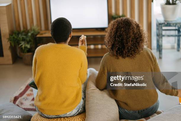 girlfriends are watching their favorite tv show - friends tv show stock pictures, royalty-free photos & images