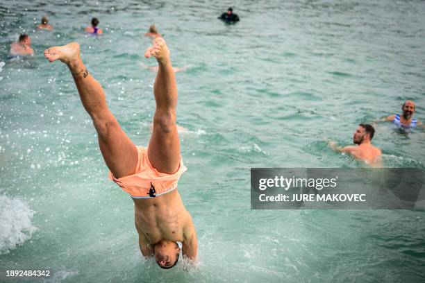 Man dives into the water during the traditional New Year's jump into the Adriatic sea in Portoroz, on January 1, 2024.