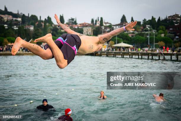 Man dives into the water during the traditional New Year's jump into the Adriatic sea in Portoroz, on January 1, 2024.